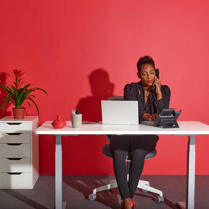 Business woman using an internet phone provider at her work