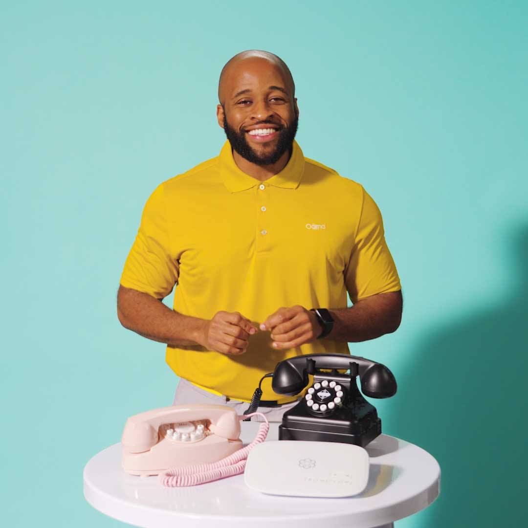An image of man trying to explain retro phones.