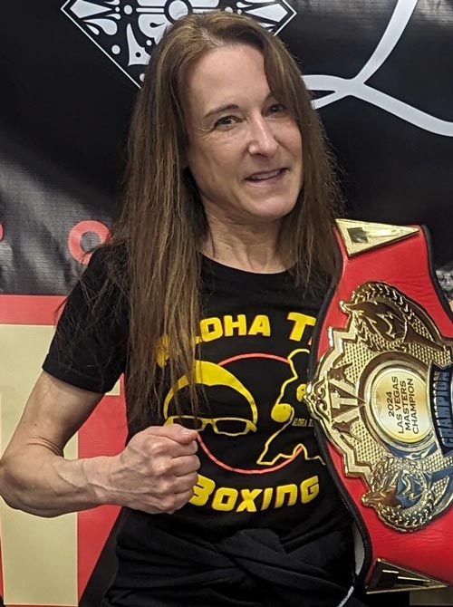 Wendy Giblin poses with her 2024 Las Vegas Masters Champion boxing belt slung over her shoulder