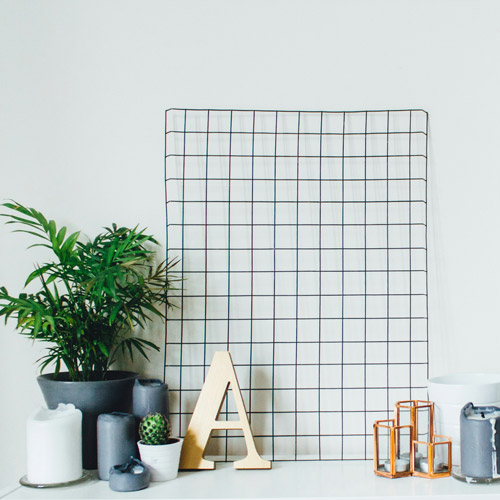 desktop with houseplants, candles and other decorations